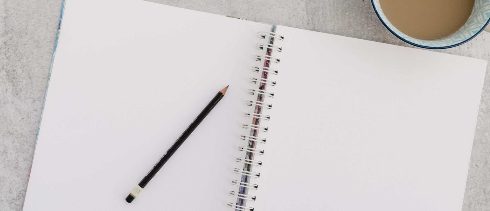 blank notebook with pencil